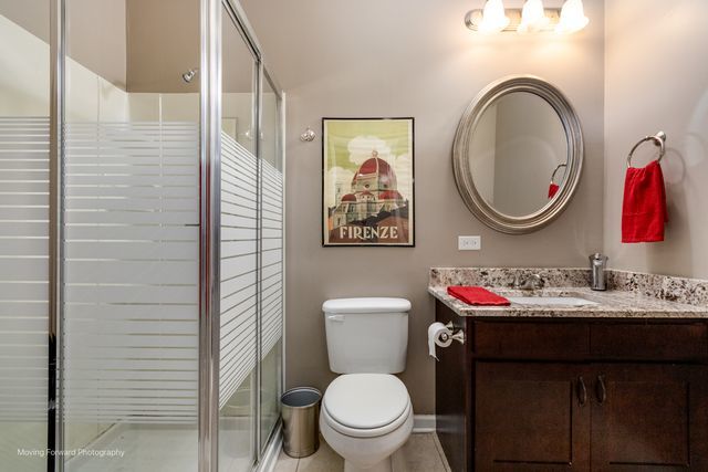 103 South Cranberry Street Bolingbrook, IL 60490 - Photo 27 of 33 a bathroom with a toilet a sink and a mirror
