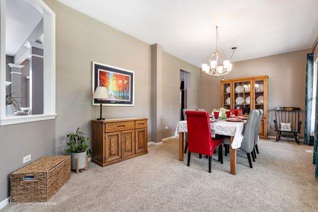 103 South Cranberry Street Bolingbrook, IL 60490 - Photo 10 of 33 a view of a dining room with furniture and chandelier