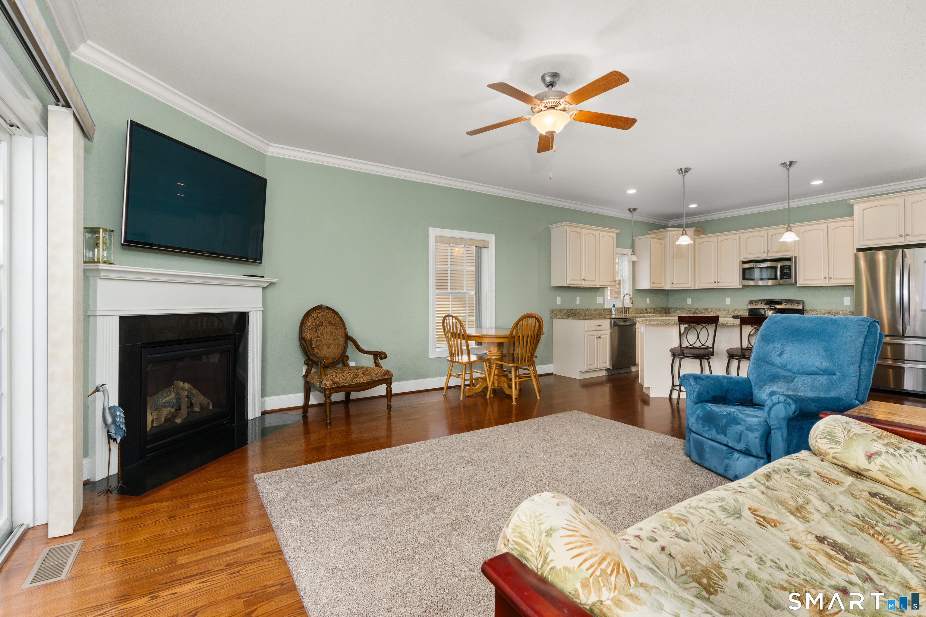 24 Center Court, Unit 24 Colchester, CT 06415 - Photo 11 of 36 a living room with furniture kitchen view and a fireplace