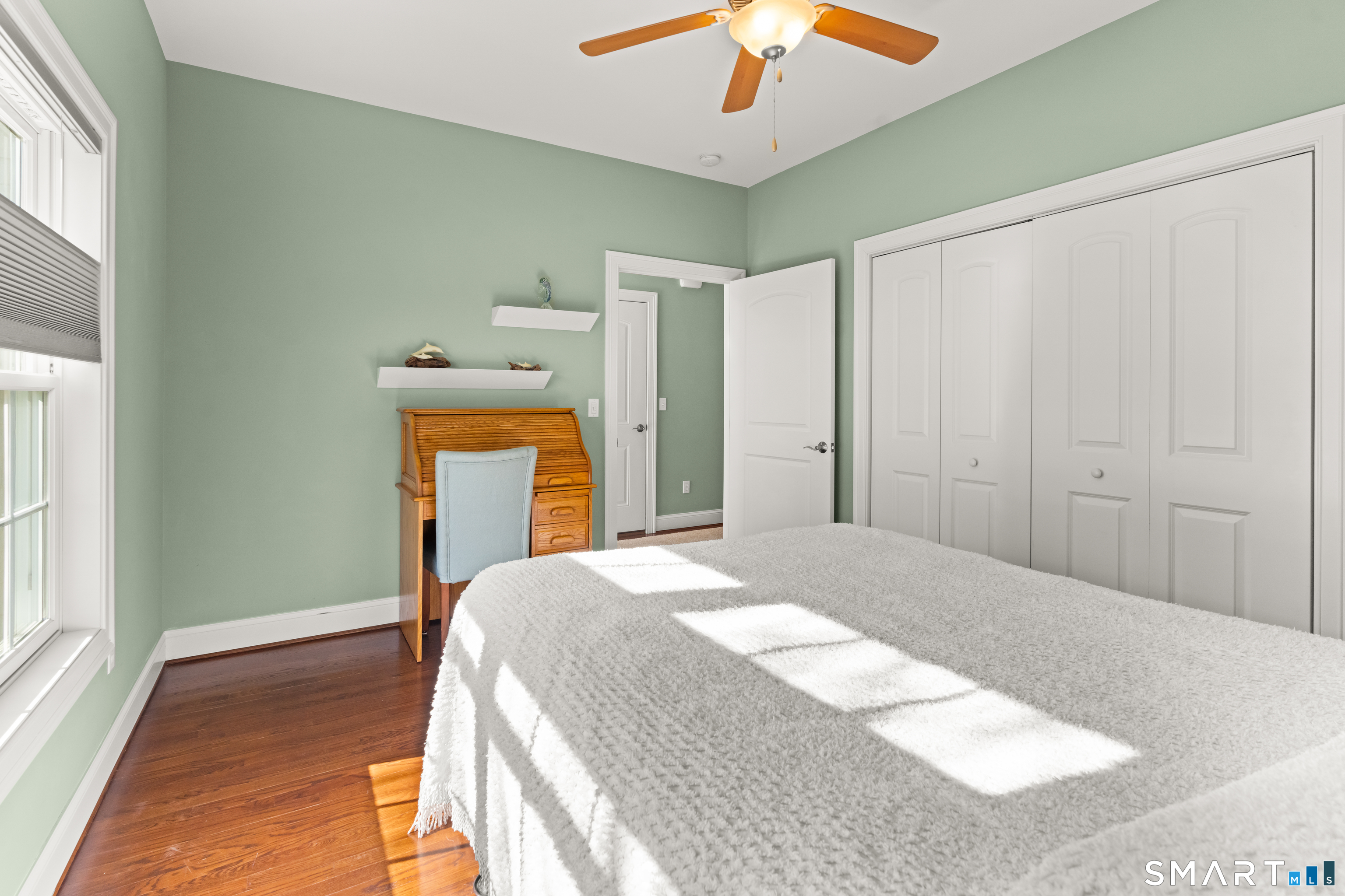 24 Center Court, Unit 24 Colchester, CT 06415 - Photo 19 of 36 a bedroom with a bed and a chandelier