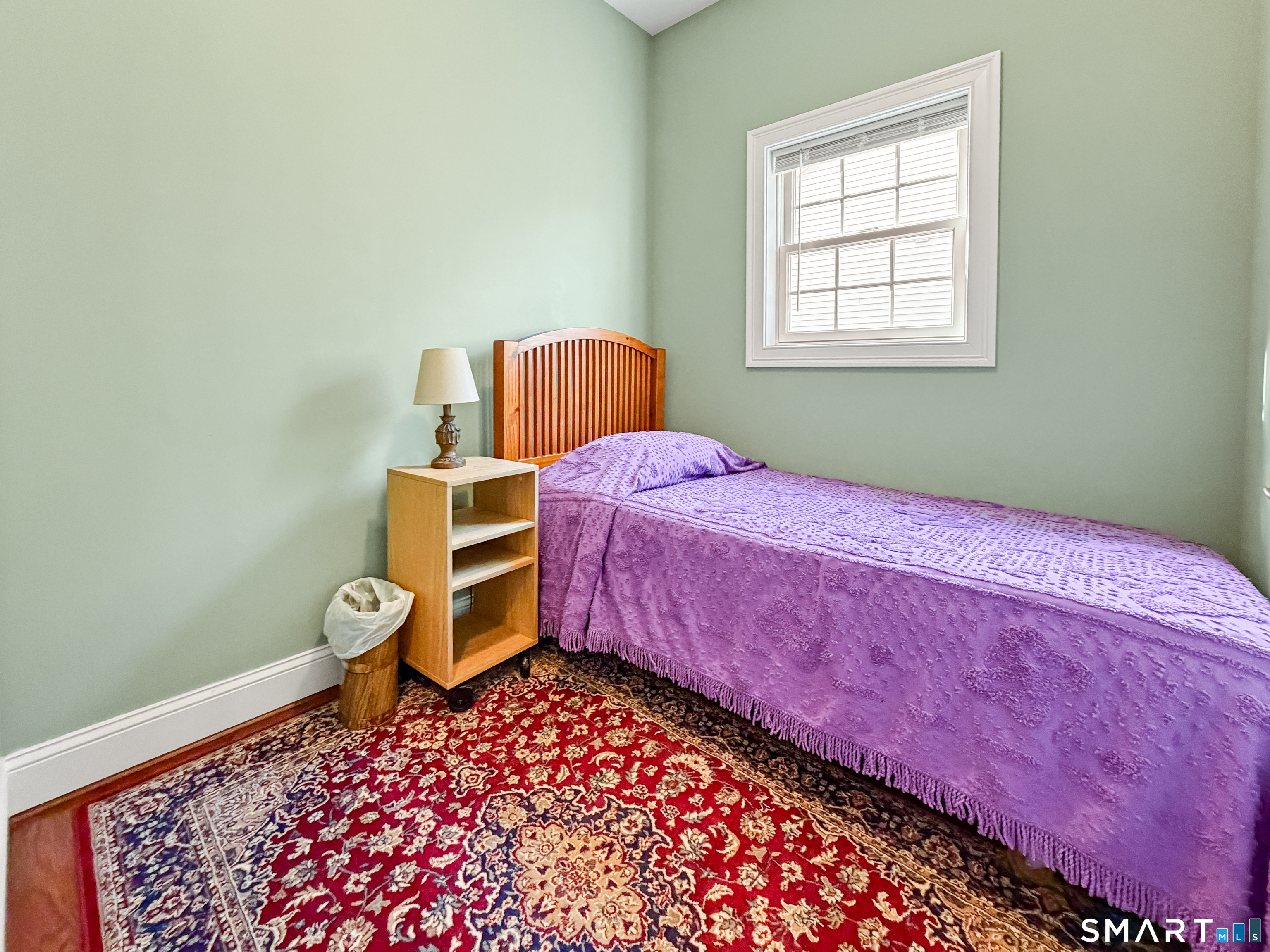 24 Center Court, Unit 24 Colchester, CT 06415 - Photo 21 of 36 a bedroom with a bed and wooden floor