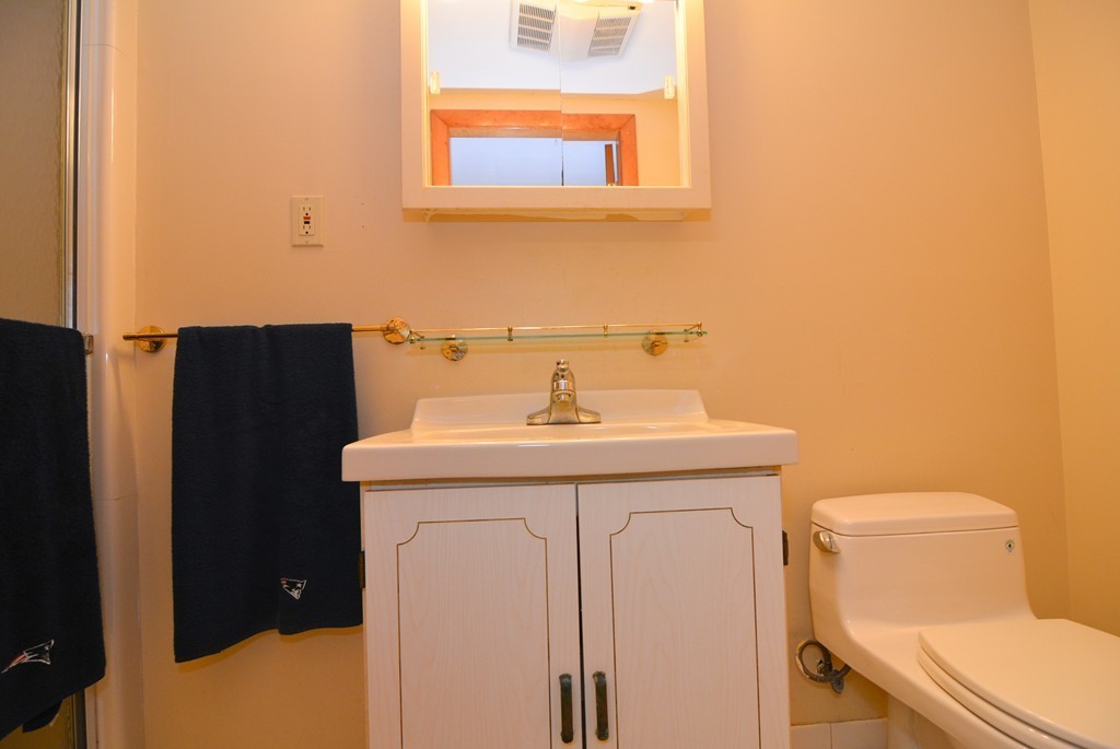 6 Cardinal Road Stoneham, MA 02180 - Photo 21 of 27 a bathroom with a sink a toilet and a mirror