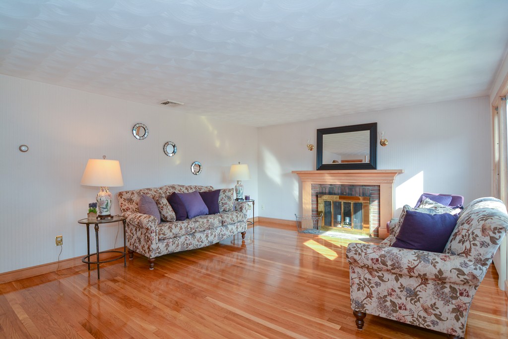 6 Cardinal Road Stoneham, MA 02180 - Photo 3 of 27 a living room with furniture and a fireplace
