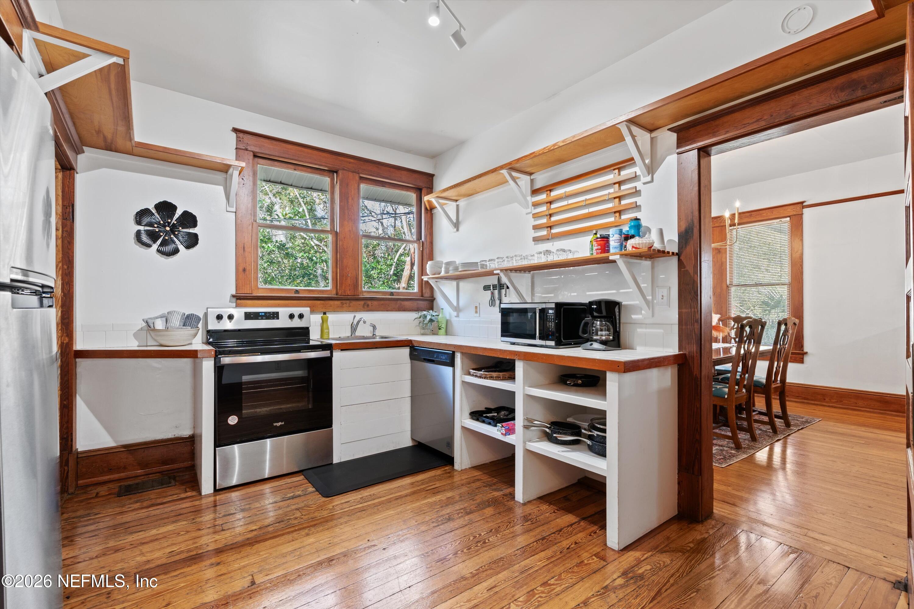 33 Cincinnati Avenue St. Augustine, FL 32084 - Photo 11 of 37 a kitchen with granite countertop a stove a sink and a refrigerator