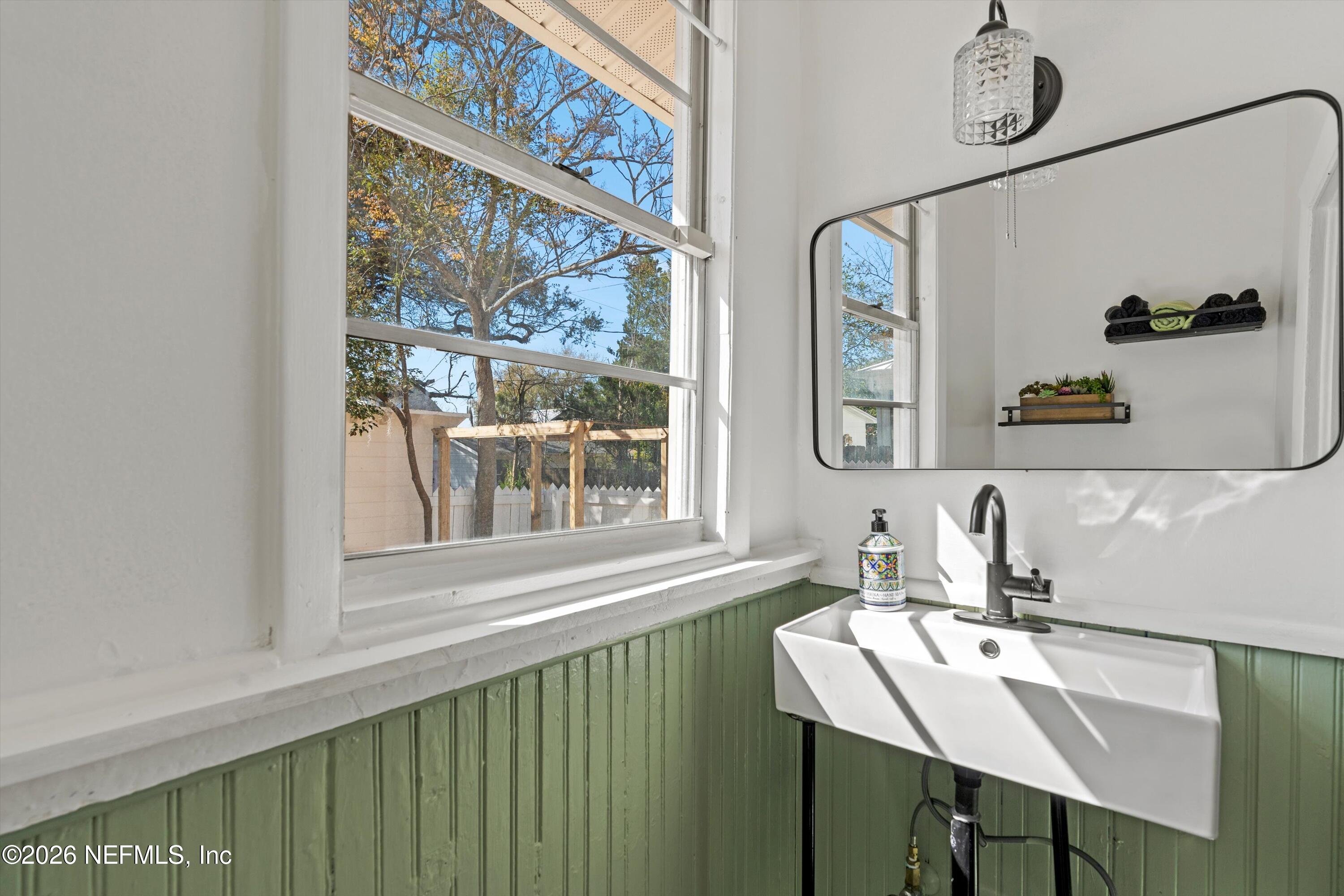 33 Cincinnati Avenue St. Augustine, FL 32084 - Photo 16 of 37 a bathroom with a sink a mirror and a window