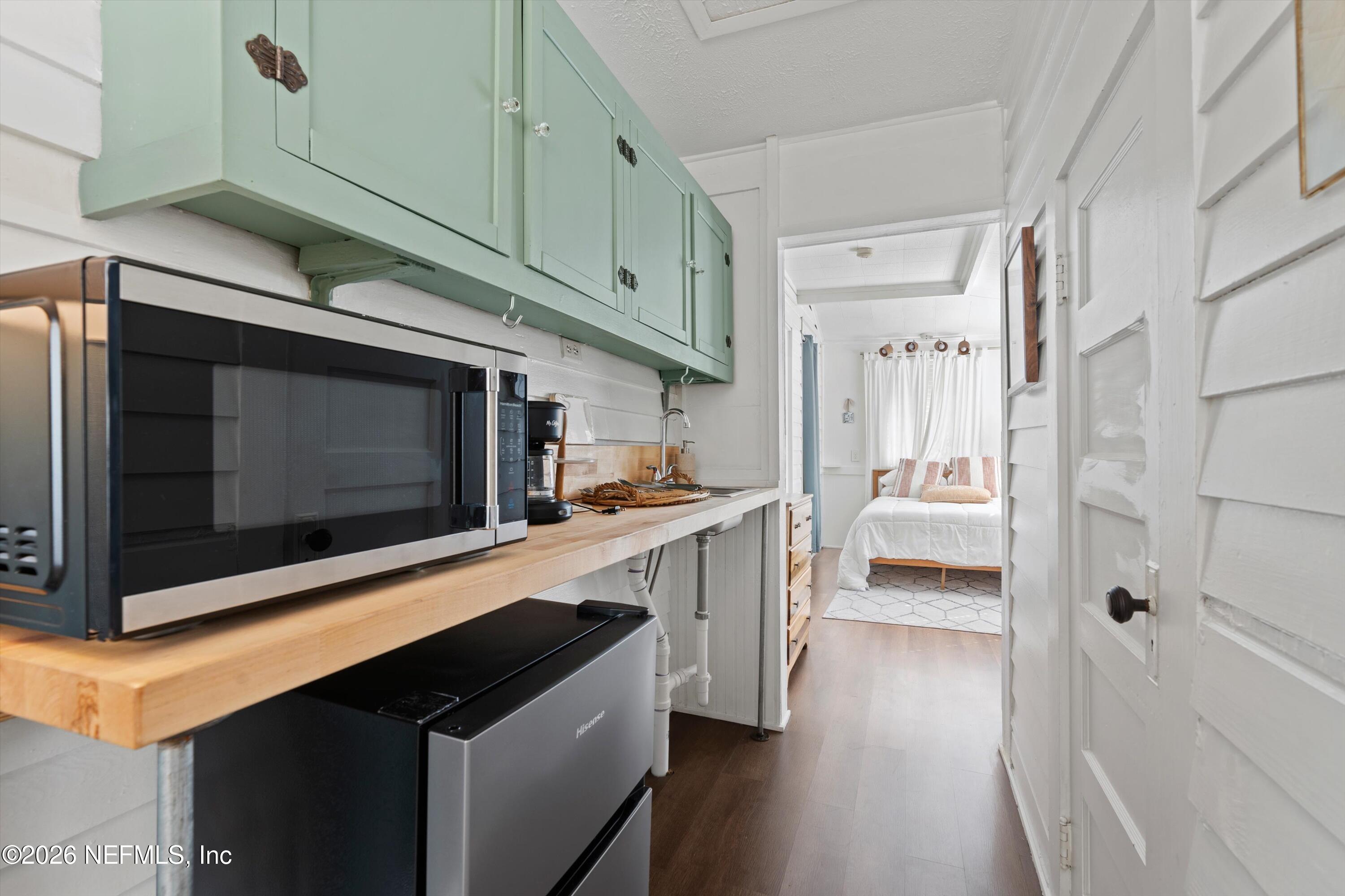 33 Cincinnati Avenue St. Augustine, FL 32084 - Photo 18 of 37 a kitchen with stainless steel appliances a stove microwave and a refrigerator