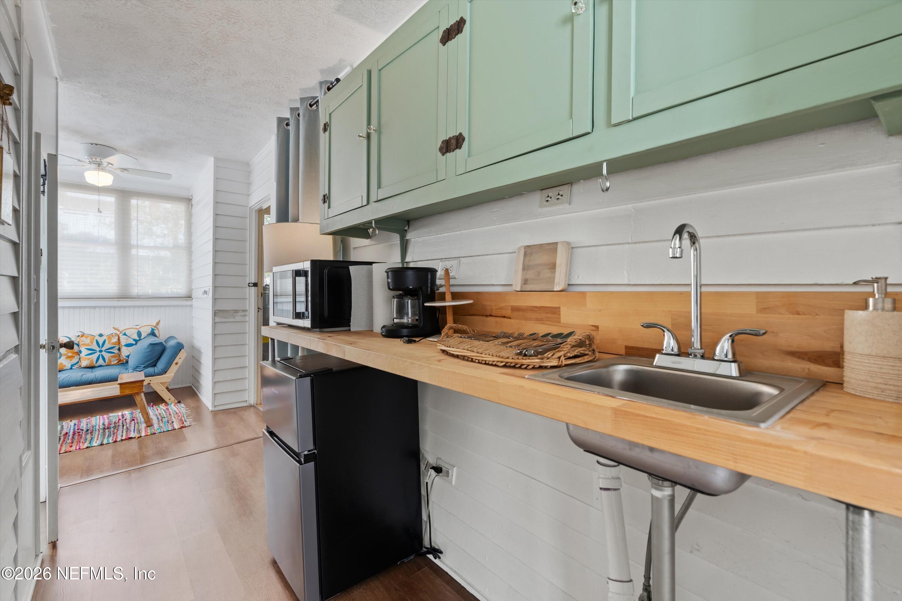 33 Cincinnati Avenue St. Augustine, FL 32084 - Photo 19 of 37 a kitchen with stainless steel appliances granite countertop a sink and cabinets