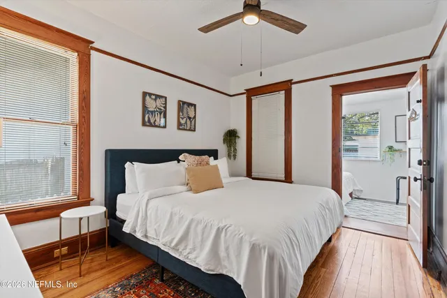 a bedroom with a bed and a large window