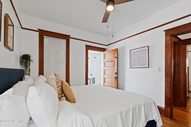a bedroom with a large bed and a chandelier