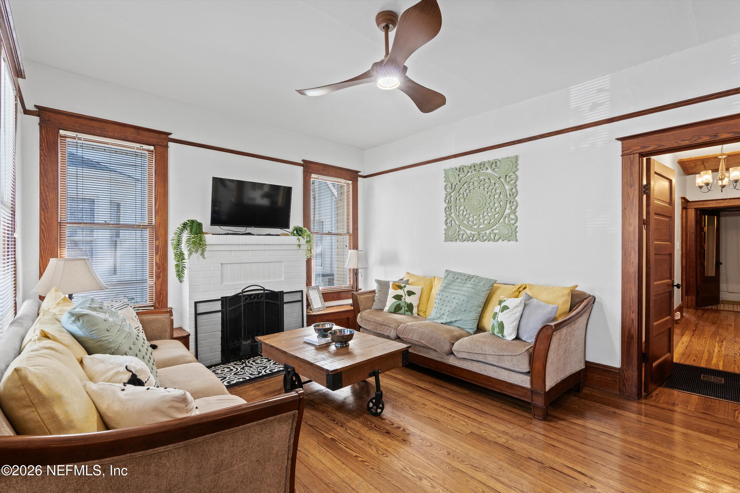 33 Cincinnati Avenue St. Augustine, FL 32084 - Photo 6 of 37 a living room with furniture a fireplace and a flat screen tv