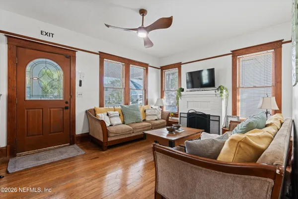 a living room with furniture a fireplace and a flat screen tv