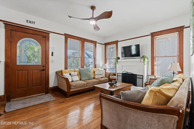 a living room with furniture a fireplace and a flat screen tv