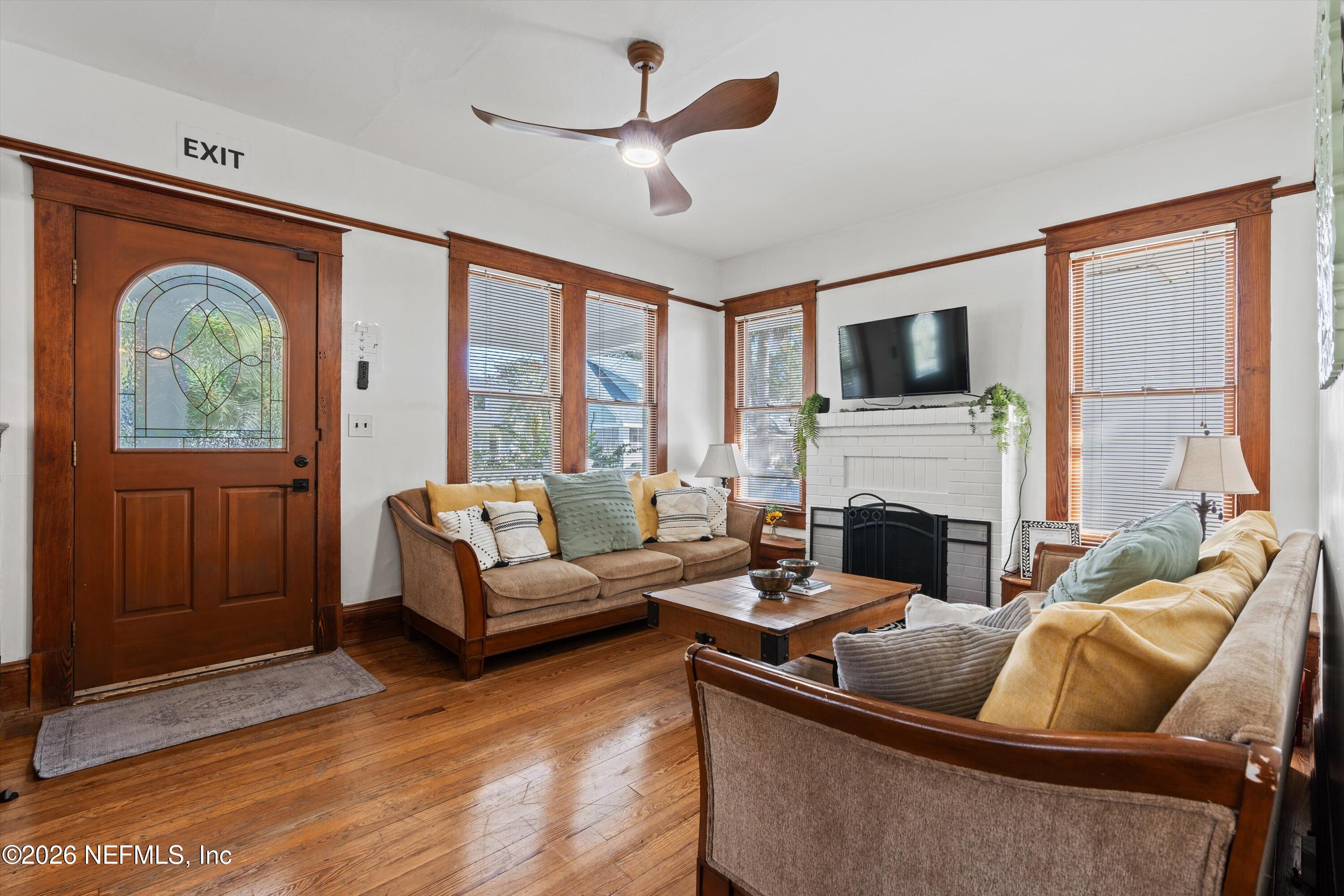 33 Cincinnati Avenue St. Augustine, FL 32084 - Photo 7 of 37 a living room with furniture a large window and a fireplace