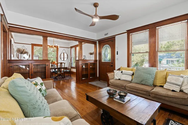 a living room with furniture a large window and a fireplace