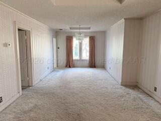 5204 Albert Avenue Amarillo, TX 79106 - Photo 6 of 17 a view of a big room with windows and chandelier