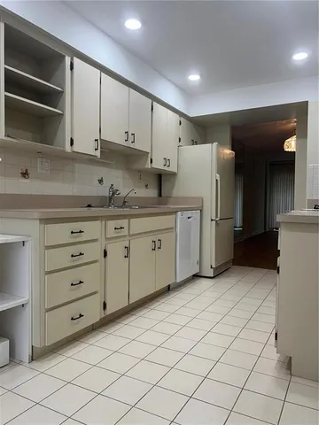 a view of a kitchen with a sink and a refrigerator