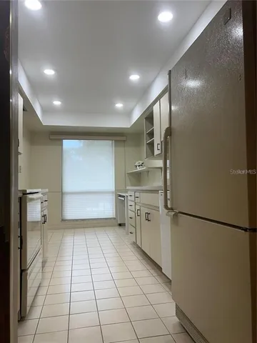 an empty room with washing machine and windows