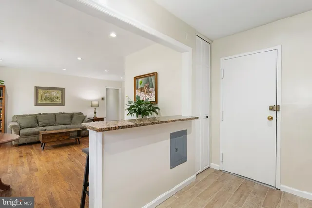a living room with kitchen island granite countertop furniture and a couch