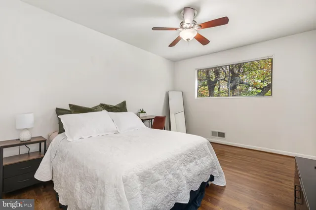 a large bed sitting in a bedroom next to a window