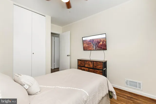 a bedroom with a bed and a painting on the wall