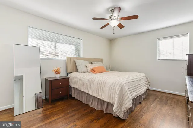 a bedroom with a bed and a ceiling fan