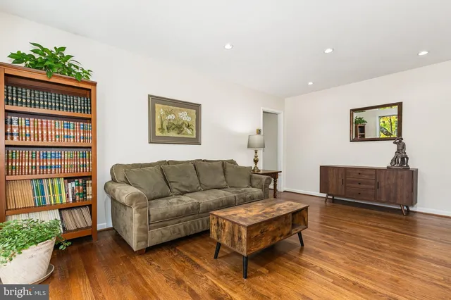 a living room with furniture a wooden floor and a window