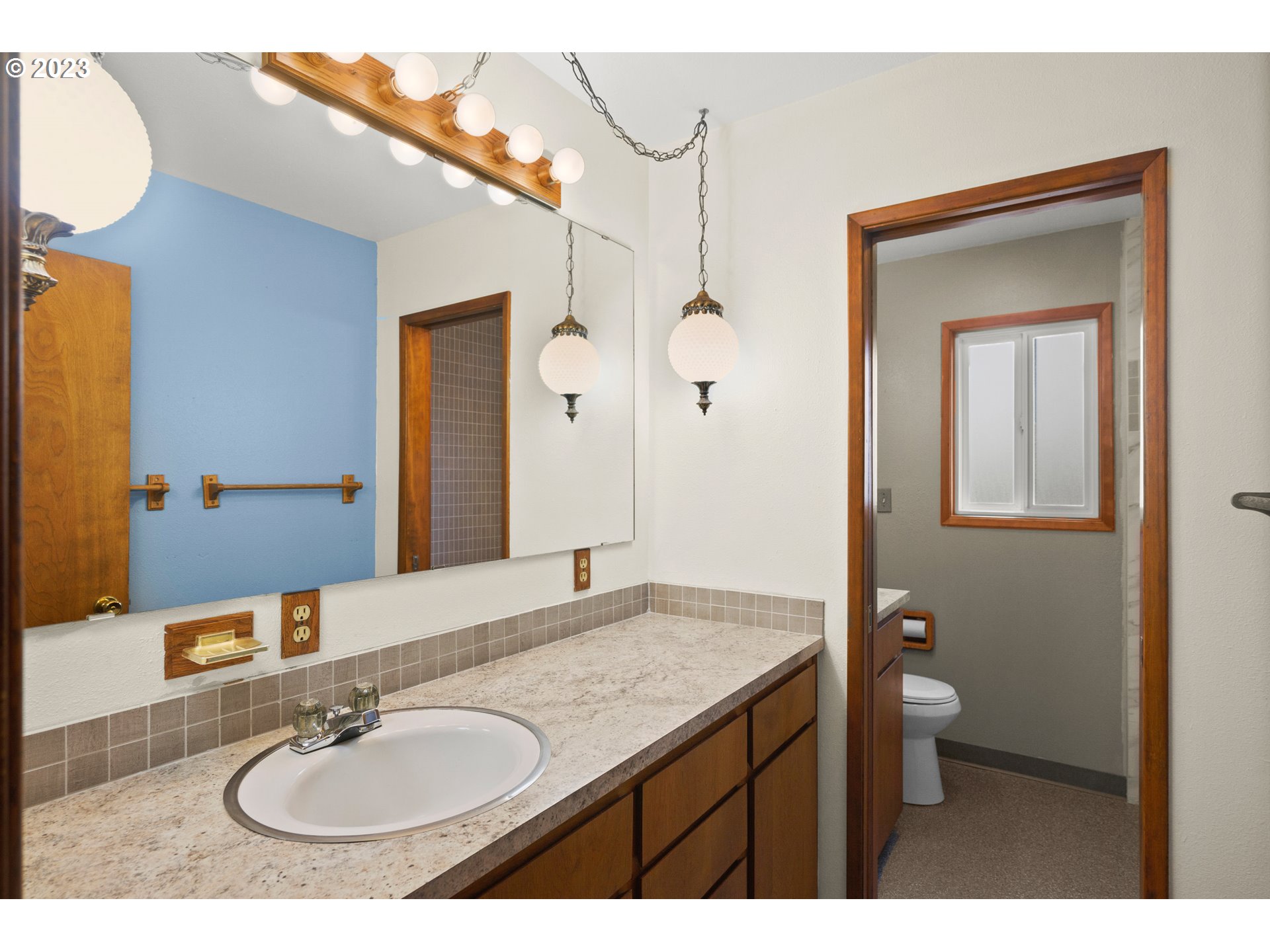 1934 Southwest Stringtown Road Forest Grove, OR 97116 - Photo 18 of 29 a bathroom with a granite countertop sink a toilet and a mirror