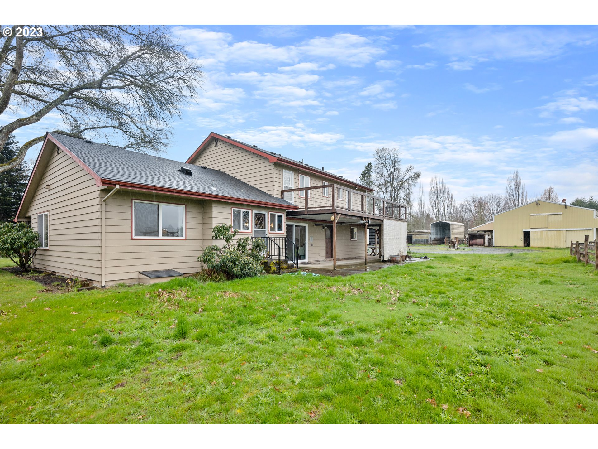 1934 Southwest Stringtown Road Forest Grove, OR 97116 - Photo 26 of 29 a view of a house with a big yard and large trees