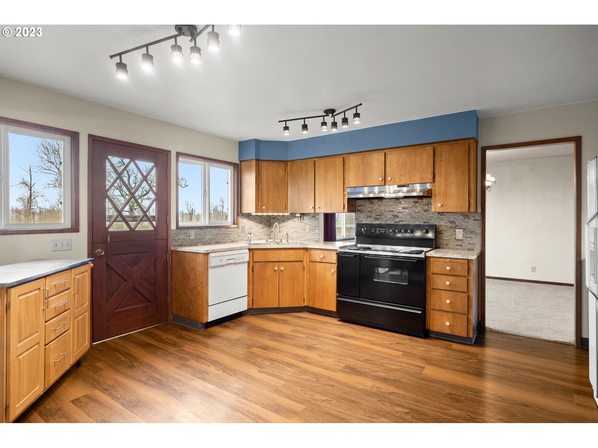1934 Southwest Stringtown Road Forest Grove, OR 97116 - Photo 5 of 29 a kitchen with granite countertop wooden floors stainless steel appliances and window