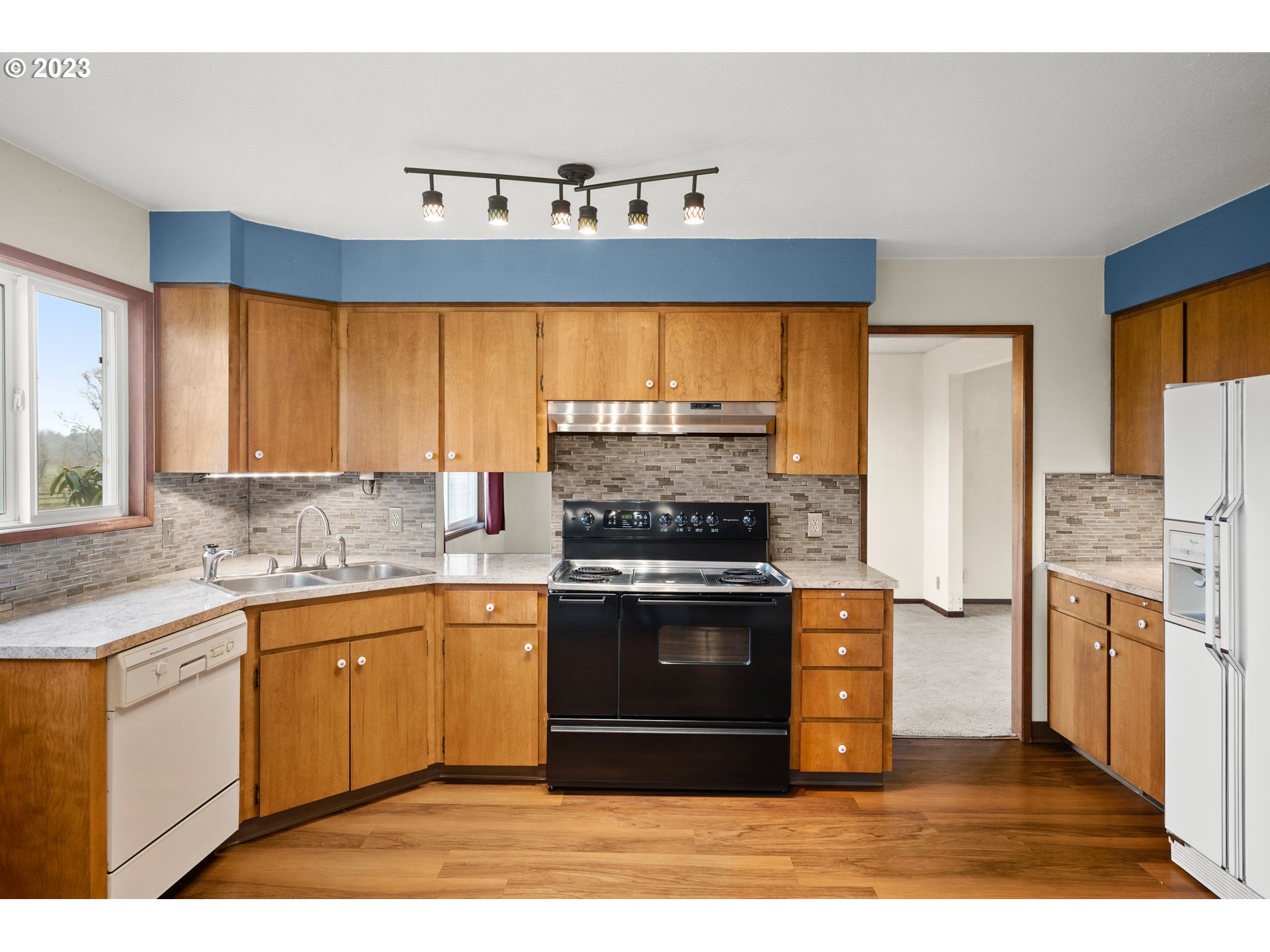 1934 Southwest Stringtown Road Forest Grove, OR 97116 - Photo 7 of 29 a kitchen with stainless steel appliances granite countertop a stove a sink and a microwave