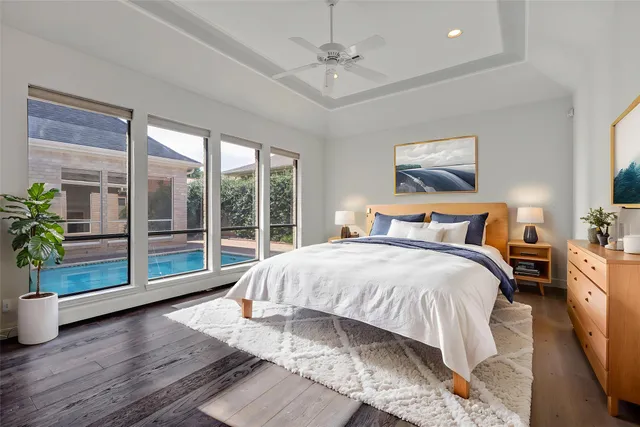 a view of an empty room with wooden floor and a fireplace