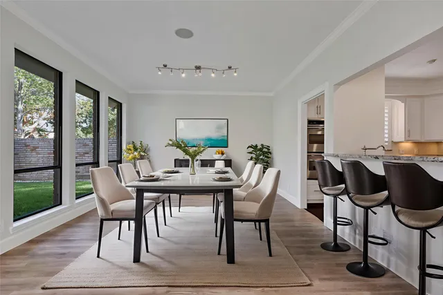a kitchen with granite countertop a stove a sink and a refrigerator