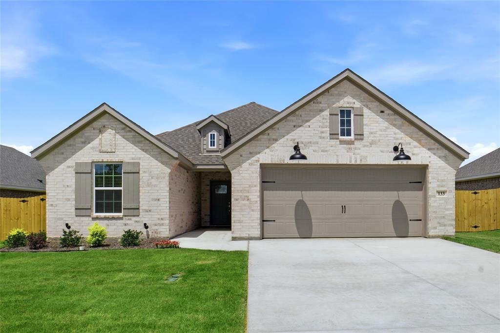 133 Joel Street Springtown, TX 76082 - Photo 1 of 15 a view of a house with a yard and garage
