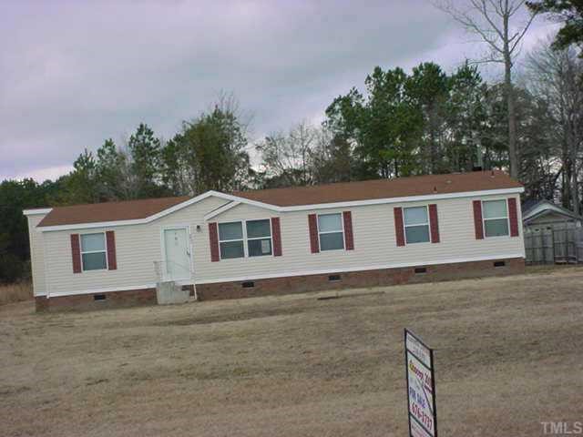6931 Sims School Road Sims, NC 27880 - Photo 3 of 3 a front view of a house with a yard and garage