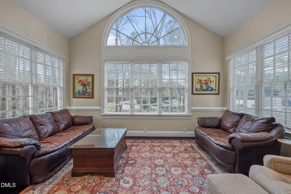 a bedroom with a large bed and flat tv screen