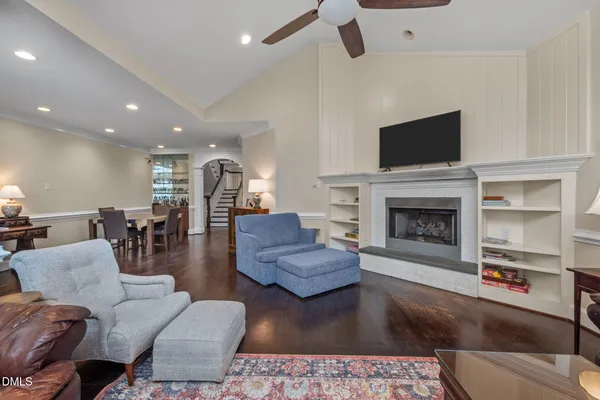 a spacious bedroom with a bed and a chandelier
