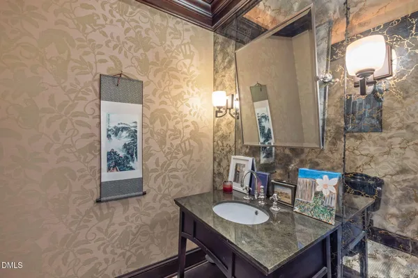 a bathroom with a granite countertop sink and a bathtub