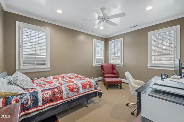 a bed room with a bed mirror and a window