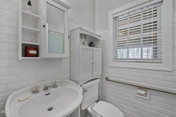 a front view of house with street view and trees