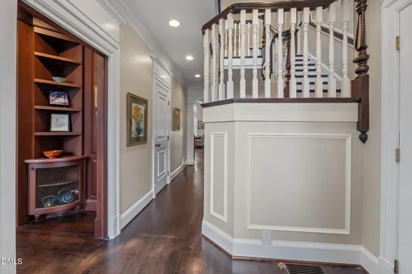 a view of a hallway with entryway and wooden floor
