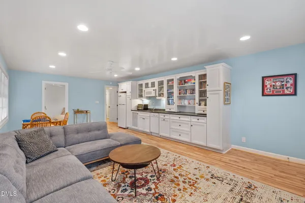 a front view of a house with a tree