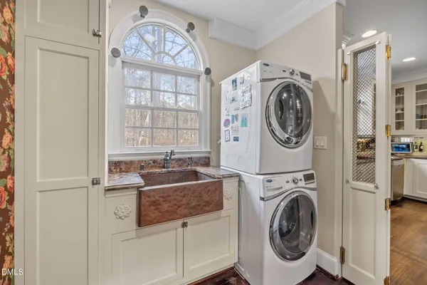 a living room with furniture a flat screen tv and wooden floor