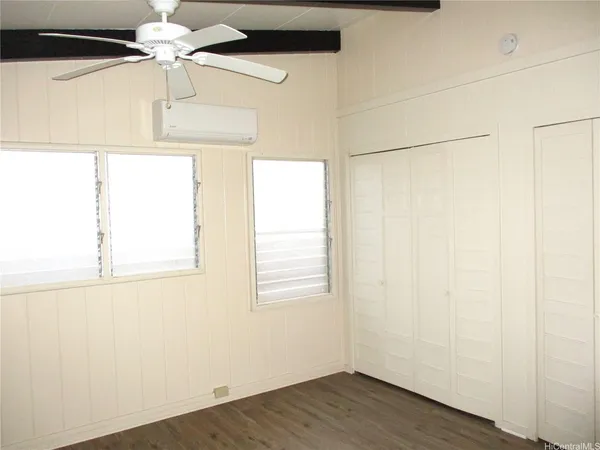 a view of a room with a window and wooden floor