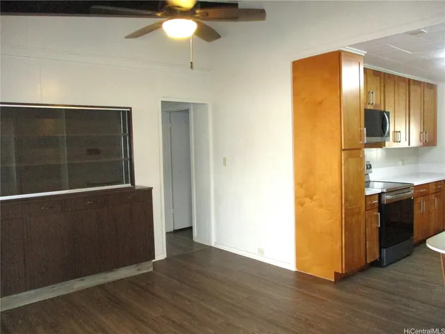 a view of a kitchen from a hallway