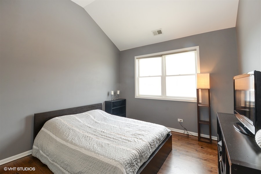 2508 West Division Street, Unit 3 Chicago, IL 60622 - Photo 8 of 10 a bedroom with a bed window tv and chair