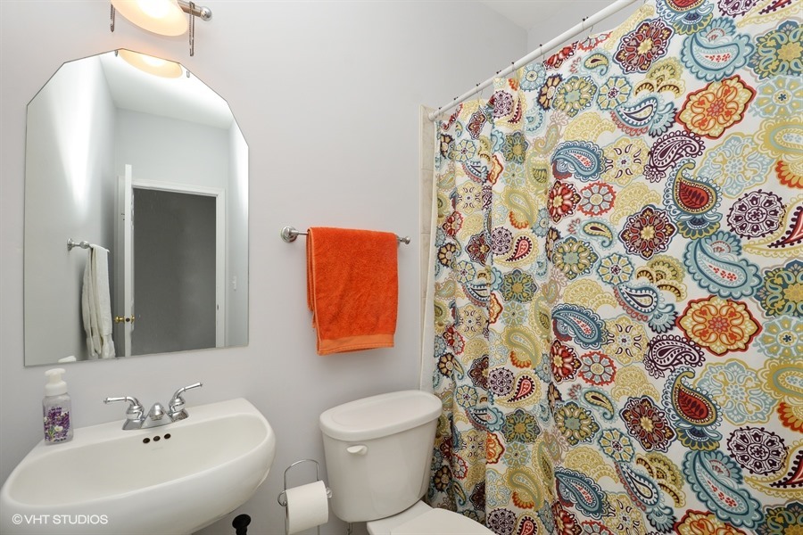 2508 West Division Street, Unit 3 Chicago, IL 60622 - Photo 9 of 10 a bathroom with a sink and mirror with toilet