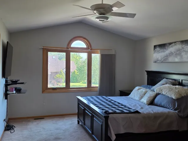 a bedroom with a bed and a window