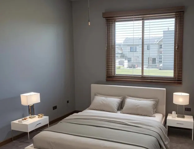 a bedroom with a bed and a lamp