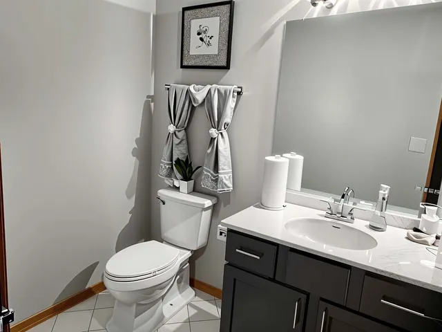 a bathroom with a sink vanity mirror and toilet