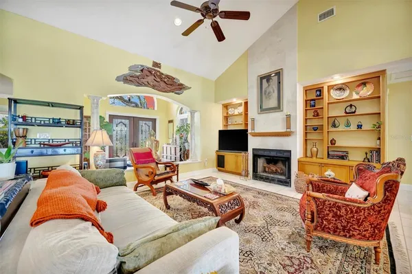 a kitchen with refrigerator and chairs